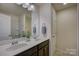 Bathroom boasts double sinks with chrome fixtures and a walk-in shower behind framed glass at 16524 Palisades Commons Dr, Charlotte, NC 28278