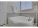 A soaking tub is adjacent to a window with lots of light at 16524 Palisades Commons Dr, Charlotte, NC 28278