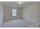 Bright bedroom with neutral carpeting and a large window providing natural light at 16524 Palisades Commons Dr, Charlotte, NC 28278