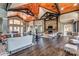 Clubhouse living room with chandeliers, stone fireplace, comfortable seating, and hardwood floors at 16524 Palisades Commons Dr, Charlotte, NC 28278
