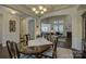 Spacious dining area with a stylish chandelier and open access to the living room at 16524 Palisades Commons Dr, Charlotte, NC 28278