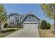 Beautiful two-story home with blue siding, white trim, a two-car garage, and a well-manicured front lawn at 16524 Palisades Commons Dr, Charlotte, NC 28278