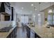 Bright kitchen with stainless appliances, stone countertops, breakfast nook, and hardwood flooring at 16524 Palisades Commons Dr, Charlotte, NC 28278
