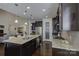 Spacious kitchen features granite counters, dark cabinetry, stainless steel appliances and hardwood floors at 16524 Palisades Commons Dr, Charlotte, NC 28278