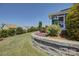 Nicely landscaped backyard with a retaining wall and colorful flowering plants at 16524 Palisades Commons Dr, Charlotte, NC 28278