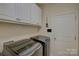 The laundry room includes cabinetry for storing laundry supplies at 16524 Palisades Commons Dr, Charlotte, NC 28278