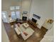 Bright living room with dark hardwood floors, fireplace, and white furniture at 16524 Palisades Commons Dr, Charlotte, NC 28278