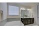 Main bathroom features a large tub and double vanity with white cabinets at 16524 Palisades Commons Dr, Charlotte, NC 28278