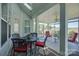 The screened-in porch has an outdoor dining table and a cozy seating area for relaxation at 16524 Palisades Commons Dr, Charlotte, NC 28278