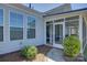 Exterior view of a cozy screened porch with an access door and stone pathway to the backyard at 16524 Palisades Commons Dr, Charlotte, NC 28278
