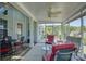 Inviting screened porch featuring comfortable seating and ceiling fan for relaxed outdoor living at 16524 Palisades Commons Dr, Charlotte, NC 28278