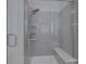 Tiled shower with a bench, and a glass door in the main bath at 16524 Palisades Commons Dr, Charlotte, NC 28278