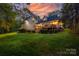 Back exterior with a wooden deck perfect for entertaining and outdoor relaxation during dusk at 2095 Westridge Dr, Rock Hill, SC 29732
