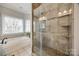 This bathroom features a glass enclosed shower and garden tub beneath a set of bright windows at 2095 Westridge Dr, Rock Hill, SC 29732