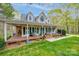 Inviting two-story home boasts a spacious porch with rocking chairs, perfect for enjoying the serene outdoor surroundings at 2095 Westridge Dr, Rock Hill, SC 29732