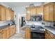Bright kitchen featuring wooden cabinets, gray countertops, and stainless steel appliances at 2095 Westridge Dr, Rock Hill, SC 29732