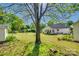 Lovely backyard with lush green grass, mature trees, and a charming white house at 2175 Highwood Rd, Rock Hill, SC 29732