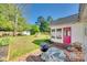 Inviting backyard patio with grill, lounge chairs and a vibrant pink door at 2175 Highwood Rd, Rock Hill, SC 29732