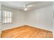 Neutral bedroom featuring wood floors, a ceiling fan, and a window with slat blinds at 2175 Highwood Rd, Rock Hill, SC 29732