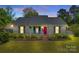 Charming home with a welcoming porch, vibrant landscaping, and a freshly painted exterior, creating an inviting curb appeal at 2175 Highwood Rd, Rock Hill, SC 29732