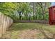 A spacious, fenced backyard provides privacy and room for outdoor enjoyment, complemented by lush trees at 2325 Sanders Ave, Charlotte, NC 28216