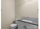 This bathroom features a white vanity with a gray countertop and a white-patterned backsplash for a classic look at 2325 Sanders Ave, Charlotte, NC 28216