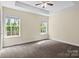 This large bedroom features two windows for natural light and soft carpet at 2325 Sanders Ave, Charlotte, NC 28216