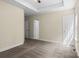 This bedroom features two windows, soft carpet, and tray ceiling at 2325 Sanders Ave, Charlotte, NC 28216