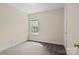 Cozy bedroom with neutral carpet and large window at 2325 Sanders Ave, Charlotte, NC 28216