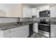 Contemporary kitchen with stainless steel appliances, white cabinetry, and sleek countertops at 2325 Sanders Ave, Charlotte, NC 28216