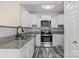 Modern kitchen with stainless steel appliances, granite countertops, white cabinets, and stylish backsplash at 2325 Sanders Ave, Charlotte, NC 28216