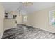 Open living room with updated floors and a view to a kitchen bar at 2325 Sanders Ave, Charlotte, NC 28216