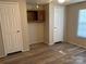 Bedroom with wood-look flooring, ceiling fan, two closets, and a window for natural light at 236 Bowmans Cutover Rd, Taylorsville, NC 28681