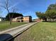 Charming single-story house and garage, surrounded by lush lawn and trees, under a clear blue sky at 236 Bowmans Cutover Rd, Taylorsville, NC 28681