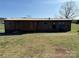 A single-story home featuring a side porch, wood siding, and a metal roof at 236 Bowmans Cutover Rd, Taylorsville, NC 28681