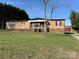 Cozy home with a covered porch and a separate garage, nestled on a lush green lawn under a clear sky at 236 Bowmans Cutover Rd, Taylorsville, NC 28681