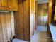 Hallway features linoleum floors and wood-paneled walls leading to another room at 236 Bowmans Cutover Rd, Taylorsville, NC 28681