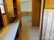 Hallway with linoleum flooring, wood paneling and a view into the living room at 236 Bowmans Cutover Rd, Taylorsville, NC 28681