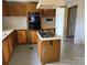 Kitchen with laminate countertops, wood cabinetry, and cooktop island at 236 Bowmans Cutover Rd, Taylorsville, NC 28681