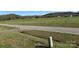 Scenic road with fields stretching to distant hills, showcasing a blend of rural tranquility and natural beauty at 236 Bowmans Cutover Rd, Taylorsville, NC 28681