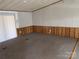 Spacious living room with carpet flooring and wood-paneled wainscoting at 236 Bowmans Cutover Rd, Taylorsville, NC 28681
