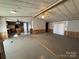 Spacious living room with wood-look flooring, ceiling fan and view to the kitchen at 236 Bowmans Cutover Rd, Taylorsville, NC 28681