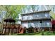 Rear exterior view featuring a deck, gazebo, stairs, and mature landscaping at 245 Clontz Hill Rd, Troutman, NC 28166