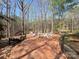 Outdoor patio with seating area, surrounded by natural wooded beauty, for peaceful enjoyment at 245 Clontz Hill Rd, Troutman, NC 28166