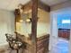 Rustic basement bar with wooden countertop, stools and view to another room with sink at 245 Clontz Hill Rd, Troutman, NC 28166