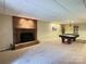 The basement features a fireplace with brick surround and a pool table at 245 Clontz Hill Rd, Troutman, NC 28166
