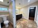 This bathroom features a dark vanity with granite counters and a separate toilet at 245 Clontz Hill Rd, Troutman, NC 28166