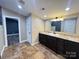 This bathroom features a dark vanity with granite counters and a separate entrance at 245 Clontz Hill Rd, Troutman, NC 28166