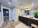 Stylish bathroom features a large vanity with granite countertops, a vessel sink and tiled floor at 245 Clontz Hill Rd, Troutman, NC 28166