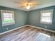 Bright bedroom showcasing hardwood floors and natural light through windows at 245 Clontz Hill Rd, Troutman, NC 28166
